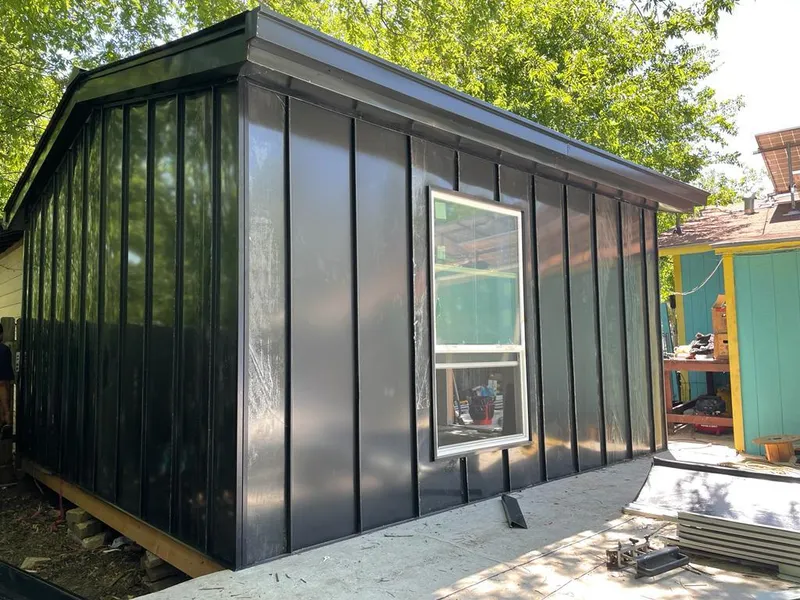 Black standing seam metal wall panels for Roof Inspection in North Valley