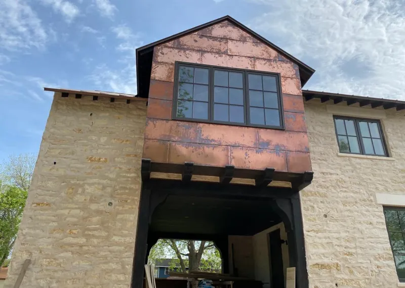Copper metal panel facade on a stone building for Roof Repair in North Valley