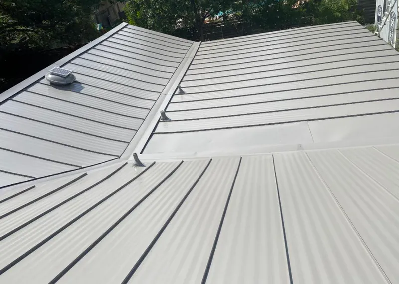 Solar attic fan installed on a metal roof for Roof Ventilation in North Valley